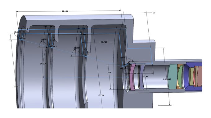 Dimensioned CAD section of a baffled lens housing with the optical elements seated inside.